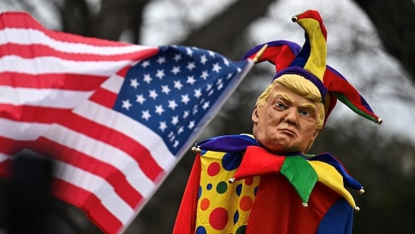 An effigy of US President Donald Trump dressed as a jester is seen at a protest in Washington, DC, on 5 February 2025 (Drew Angerer/AFP)