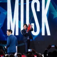 President of Argentina Javier Milei arrives on stage with a custom chainsaw before Elon Musk and Nesmax Host Rob Schmitt before speak, during day 1 of the 2025 Conservative Political Action Conference, February 20, 2025. Graeme Sloan | AP