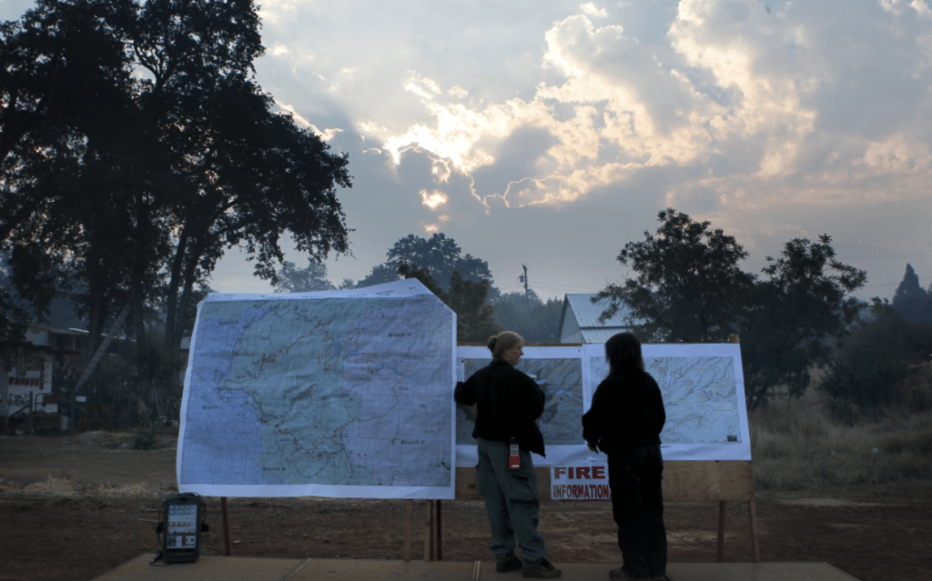 Firefighters check updated information after their morning meeting at base camp in Tuolumne City California in 2013 as the Rim Fire burns Stanislaus National ForestMichael MacorThe San Francisco Chronicle via Getty Images