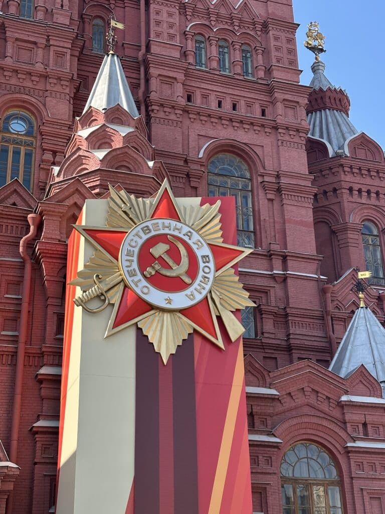 RedSquaremedal768x1024 | MR Online Moscow is decked out in red banners and Soviet symbols in preparation for the upcoming 80th anniversary of the defeat of fascism in World War II Though the government leans heavily on Soviet imagery these days Russias Communists say it represents a selective appropriation of the USSRs legacy by the ruling class which has built nothing of its own This installation on Red Square photographed on April 22 2025 shows the Soviet hammer and sickle on a giant reproduction of a medal issued to soldiers during the war which in Russia is known as the Great Patriotic War | CJ Atkins Peoples World