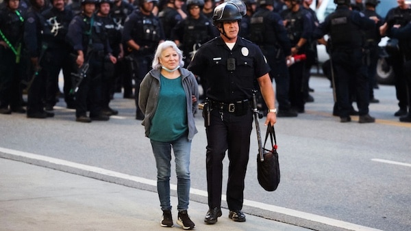  | An LAPD officer escorts a protester during mass arrests at an anti ICE demonstration in Los Angeles June 10 2025 Marcio Jose Sanchez | AP | MR Online