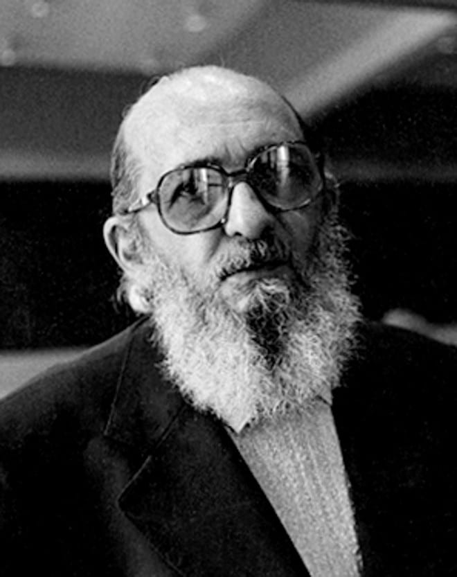MR Online | A black and white photograph of Paulo Freire later in life Freire is bald bearded and wears large eyeglasses | MR Online