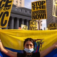 A person holds the flag of Ecuador as people protest against deportations in New York City, on 10 June 2025 (Adam Gray/Getty Images via AFP)