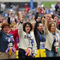DELEGATES RAISE SOLIDARITY FISTS AT THE NEA’S 2025 REPRESENTATIVE ASSEMBLY. (PHOTO: NATIONAL EDUCATION ASSOCIATION)