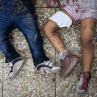 The bodies of two children lie on the hospital floor of a Project Hope-run medical clinic in Deir el-Balah, after an Israeli strike [Abdel Kareem Hana/AP Photo]