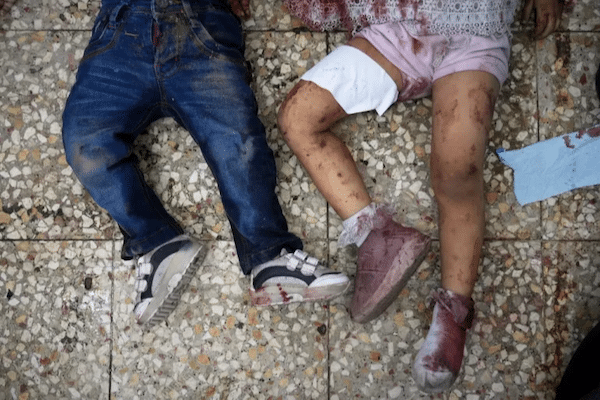 MR Online | The bodies of two children lie on the hospital floor of a Project Hope run medical clinic in Deir el Balah after an Israeli strike Abdel Kareem HanaAP Photo | MR Online