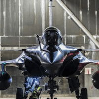 A Rafale BF3 practices alert in a protective aircraft shelter at an unknown base (potentially Saint Dizier) with an ASMPA nuclear cruise missile shape attached to its center pylon. (Credit: French Air Force).