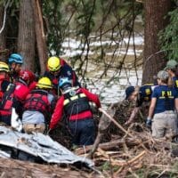 A crew of firefighters from Ciudad Acuna, Mexico, left, aid in search and rescue efforts near the Guadalupe River after a flash flood swept through the area, Monday, July 7, 2025, in Ingram, Texas. [AP Photo/Eli Hartman]