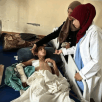 11-year-old Musa al-Shaer lies on a hospital bed at Nasser Hospital on August 13, 2025 in Khan Yunis, Gaza, after being injured while going to collect food from humanitarian aid point in Rafah, southern Gaza. [Doaa Albaz – Anadolu Agency]