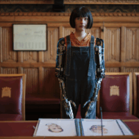 Ai-Da Robot, the world's first ultra-realistic humanoid robot artist, appears at a photo call in a committee room in the House of Lords on October, 2022. (Credit: Rob Pinney via Getty Images.)