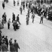 At the heart of the pogrom group, an individual wearing a white armband can be seen. This is the distinctive sign of the members of the Ukrainian militia, who are, for the most part, members of the Organization of Ukrainian Nationalists, the OUN, particularly its most radical faction, led by Stepan Bandera, the OUN(B). (United States Holocaust Memorial Museum, courtesy of Leonard Lauder)