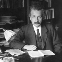 A photo of Albert Einstein seated at a desk.