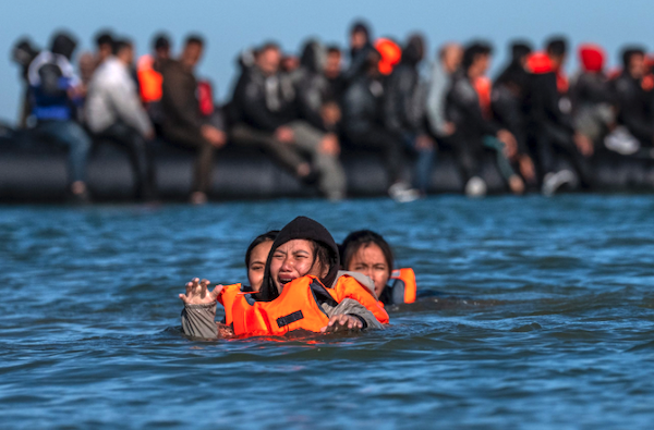A woman fails to board a migrant dinghy into the English Channel on August 25, 2025 in Gravelines, France. (Credit: Carl Court via Getty Images.)