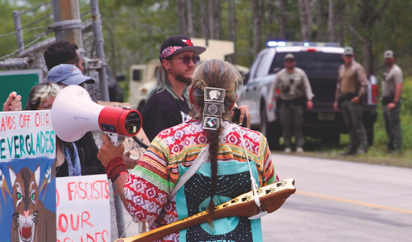 MR Online | Carlos OchoaShutterstock Protesters line the highway in the Florida Everglades to oppose the construction of Alligator Alcatraz June 2025 | MR Online