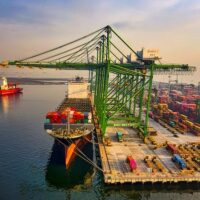Aerial view of a container port in Jakarta, Indonesia with ships and cranes. Photo: Tom Fisk
