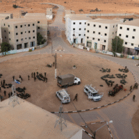 Israeli occupation forces gather at the immersive theater set known as the Urban Warfare Training Center or “Mini Gaza” at Wadi al-Sayal (Tze’elim), an-Naqab (Negev) desert, occupied Palestine, Jan. 4, 2022. Photo: Oded Balilty/Associated Press.