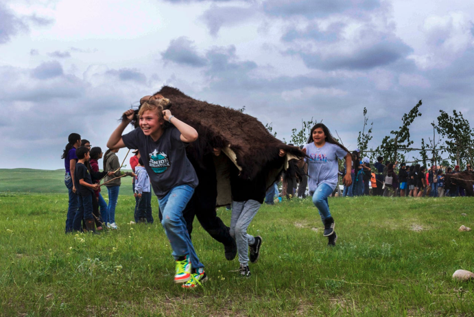 Blackfeet kids re-enact a buffalo drive. [Source: huffpost.com]