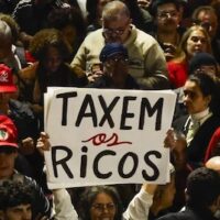 People attend a demonstration in support of taxing the super-rich in São Paulo, Brazil on July 10, 2025. (Photo by Miguel Schincariol/AFP via Getty Images)