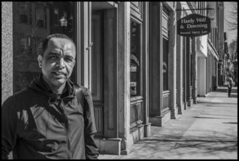 Mohamed Ali Ibrahim is a leader of the Somali Bantu community, and stands on Main Street, where Somali stores have taken the place of boarded-up storefronts.| David Bacon