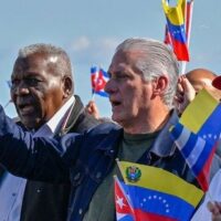 Cuban President Miguel Diaz-Canel waves a Venezuelan national flag in Havana on January 3, 2026. (Photo by Adalberto Roque/AFP via Getty Images)