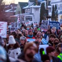 Demonstrators protest ICE in Minneapolis after DHS agents killed Alex Pretti and Renee Good. Organizers say a government shutdown will not stop ICE, which now operates on multi-year funding passed by Congress.