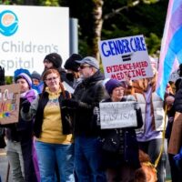 Trans rights supporters protest outside of Seattle Children's Hospital after the institution postponed some gender-affirming surgeries for minors following an executive order by President Donald Trump, Feb. 9, 2025, in Seattle. The hospital is now being targeted by the Department of Health and Human Services as part of a scheme by Sec. Robert F. Kennedy to deny Medicare and Medicaid funds to hospitals providing gender affirming care. | Lindsey Wasson / AP