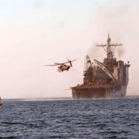 Haiti (Feb. 10, 2010) A helicopter takes off from the amphibious dock landing ship USS Fort McHenry (LSD 43) as a fishing boat sails past off the coast of Haiti. Fort McHenry is conducting humanitarian and disaster relief operations as part of Operation Unified Response after a 7.0 magnitude earthquake caused severe damage in and around Port-au-Prince, Haiti Jan. 12. (U.S. Navy photo by Mass Communication Specialist 1st Class (SW) Rachael L. Leslie/Released)