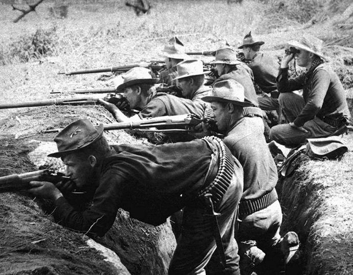 U.S. troops fire on Filipino insurgents from trenches dug by Black soldiers like Fagen. [Source: allthatsinteresting.com]