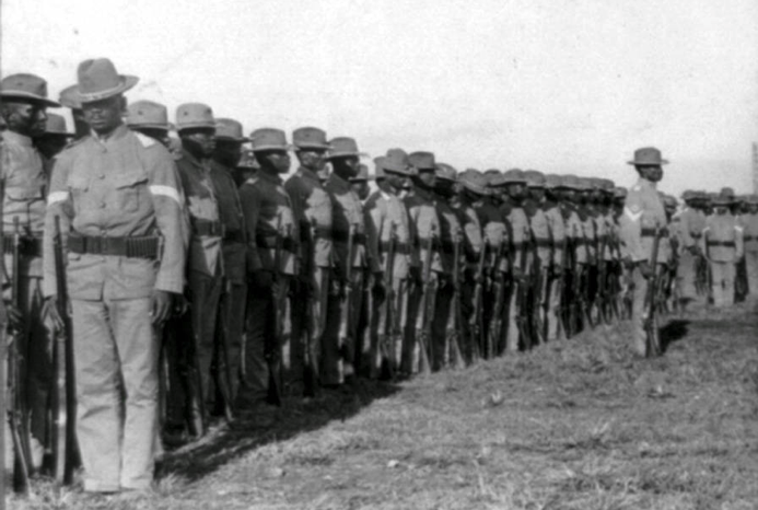 The U.S. 24th Infantry Regiment, a regiment made up of African-Americans, stands at attention. [Source: allthatsinteresting.com]