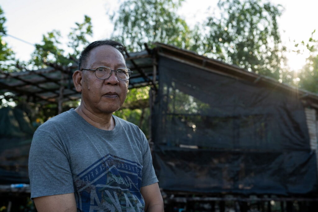 A portrait of environmental activist Chaweerat Phanprasirt, otherwise known as Toy, in Chonburi province, Thailand, in December 2025. Photo by Andy Ball for Mongabay.
