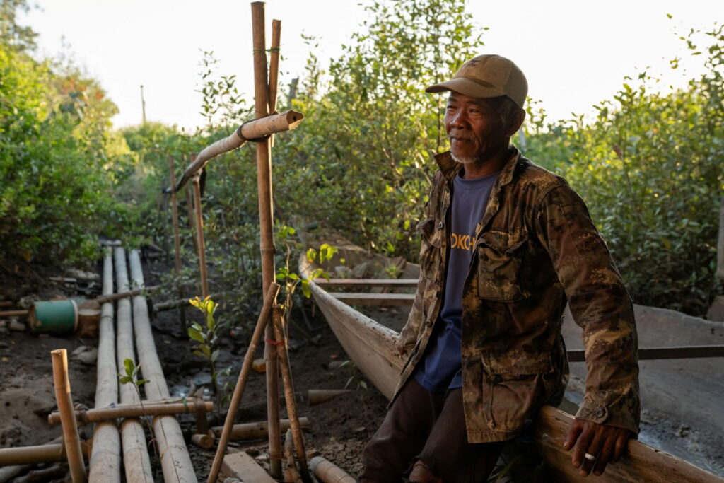 Sengchan Supalat, a fisher whose family has been fishing in the Khlong Tamru canal for generations, stands for a portrait in December 2025. Photo by Andy Ball for Mongabay.