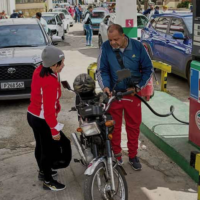 A driver refuels a motorcycle as other drivers wait in a long line at a petrol station in Havana, Cuba, Friday, January 30 2026