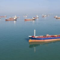 Tankers sit idle outside the Strait of Hormuz as Iran’s blockade halts 90% of commercial transit through the world’s most critical energy chokepoint.