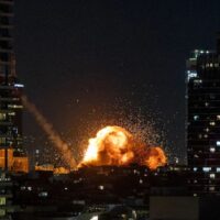 Fire and smoke rise in Tel Aviv following the impact of an Iranian missile fired in retaliation to US-Israeli aggression on February 28, 2026. Photo: Chaim Goldberg/Flash90.
