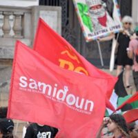 A flag displaying the logo of Samidoun is seen at a Palestine solidarity demonstration in São Paulo, Brazil, February 15, 2025. Photo courtesy Samidoun Network/X.