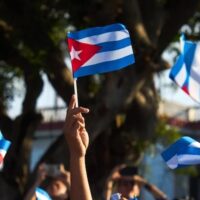 Women wave Cuban flags during a rally calling for the end of the US blockade against the island nation in Havana, Cuba, April 7, 2026