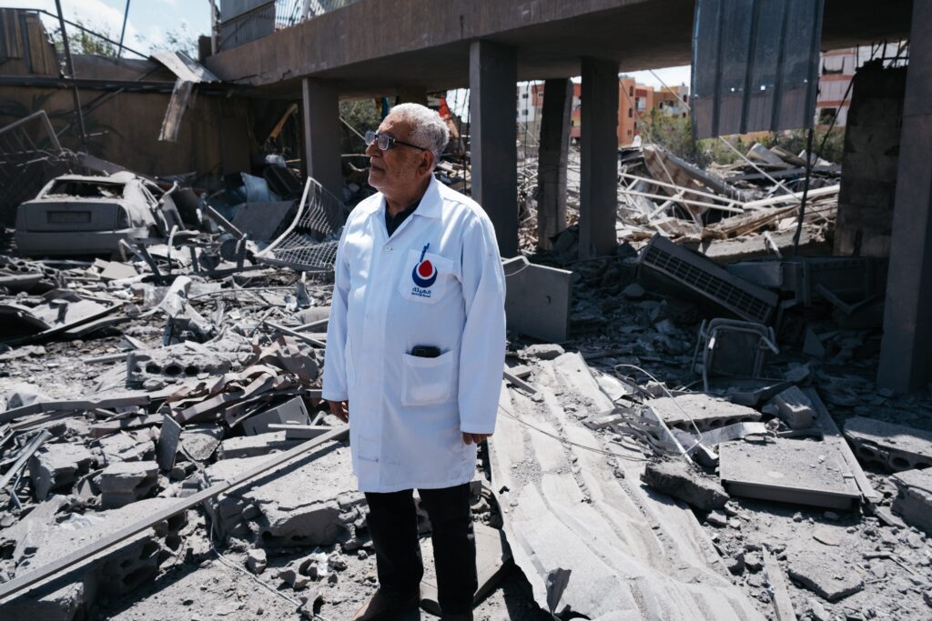 A doctor stands in the rubble of a primary healthcare centre in Maashouq, Tyre district, after a May 18 Israeli airstrike. May 20, 2026.