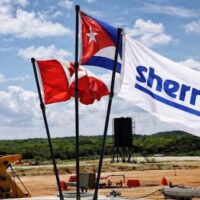 The flag of the Sherritt mining and energy company flies alongside Cuban and Canadian flags at one of the company's facilities in Cuba. | Sherritt International