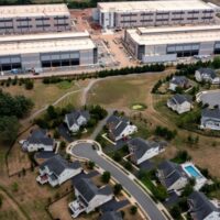 An Amazon Web Services data center is shown situated near single-family homes. Some local and state officials across the country want to halt development of the facilities. (Photo by Nathan Howard/Getty Images)