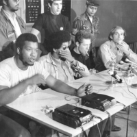 Fred Hampton, of the Black Panthers, seated from left, Pablo Guzman, of the Young Lords of New York, Jose “Cha-Cha” Jimenez, founder of the Young Lords of Chicago, and Mike Klonsky, of Students for a Democratic Society, at a news conference in Chicago on Oct. 10, 1969.
