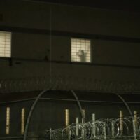 Detainees inside Delaney Hall, an ICE detention facility in Newark, bang on windows as protesters rally outside, May 24, 2026. Credit: Gwynne Hogan/THE CITY