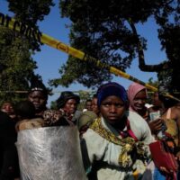 TARGETED: Malawian migrants stand in a queue for their deportation at a temporary centre, in South Africa