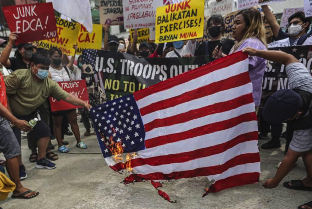Demonstrators burn a U.S. flag during a rally in front of Camp Aguinaldo military headquarters in Quezon City, Philippines, on April 11, 2023, as they protest opening ceremonies for the joint military exercise Balikatan, Tagalog for “shoulder-to-shoulder.” The U.S. and the Philippines began their largest combat exercises in decades that will involve live-fire drills, including a boat-sinking rocket assault in waters across the South China Sea and the Taiwan Strait. [Source: defensenews.com]