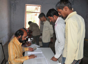 The polling officer checks the electoral roll before voters can cast their vote. Photo: Public.Resource.Org