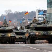 German Leopard tanks roll under German and NATO flags in Vilnius, Lithuania. Eighty-five years after Operation Barbarossa, German imperialism is again being organized for war in the East.