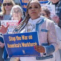 Federal workers rally against attacks on union rights and government jobs.