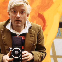 David Hockney working on the set design for the Glyndbourne production of the Magic Flute opera in 1977. (Goddard Archive Portraits / Alamy / the Conversation)