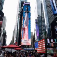 A Nasdaq display in Times Square celebrates SpaceX’s Wall Street debut. The celebration was for Musk and the bankers. Workers’ deferred wages were pushed into the gamble.