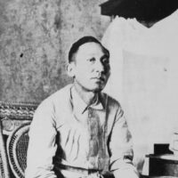 A black and white photo of Apolinario Mabini sitting in a chiar.