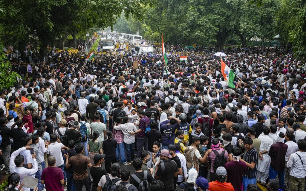 Protesters a march towards Parliament demanding the resignation of Union Education Minister Dharmendra Pradhan. Photo: PTI/Atul Yadav